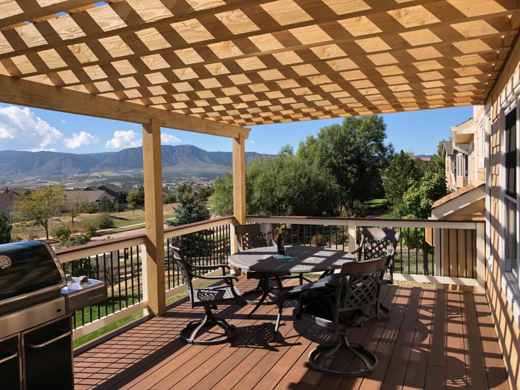 Sunny patio with pergola and mountain view.